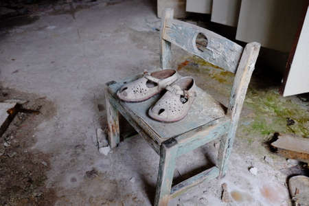 Small children's sandals in an abandoned kindergarten in Pripyat. Old children's shoes.の写真素材