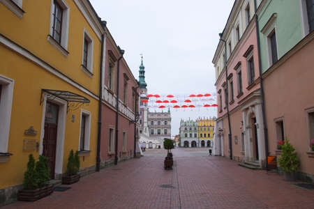 Zamosc, Poland, November 10, 2020. A street of an old European city on a cloudy autumn day. Small multi-colored old houses. Urban environment, landscape.のeditorial素材