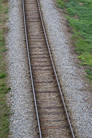 Railway bed. Fragment of railway tracks, top view, rails and sleepers.の写真素材