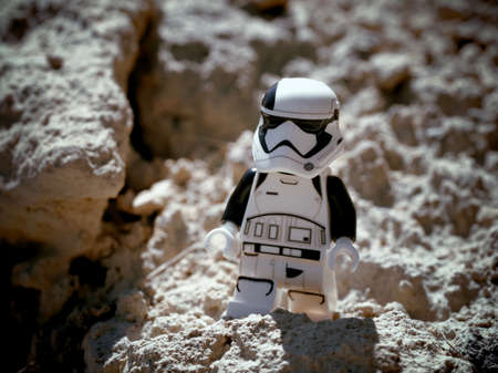 Chernihiv, Ukraine, July 13, 2021. A minifigure of an imperial stormtrooper from Star Wars against a background of sandy terrain. Illustrative editorial.のeditorial素材