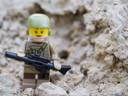 Chernihiv, Ukraine, July 13, 2021. Minifigure of a girl in a military uniform with a gun, a close-up shot. Illustrative editorial.のeditorial素材
