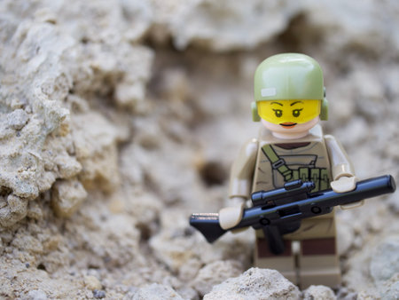 Chernihiv, Ukraine, July 13, 2021. Minifigure of a girl in a military uniform with a gun, a close-up shot. Illustrative editorial.のeditorial素材