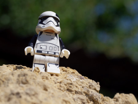 Chernihiv, Ukraine, July 13, 2021. An Imperial stormtrooper on a sandy surface. A plastic minifigure...
