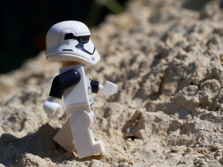Chernihiv, Ukraine, July 13, 2021. An Imperial stormtrooper on a sandy surface. A plastic minifigure of a Star Wars character. Illustrative editorial.のeditorial素材