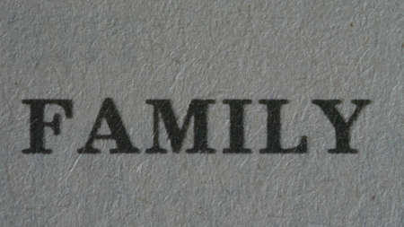 The word "family" is printed on a piece of paper, close-up.の写真素材