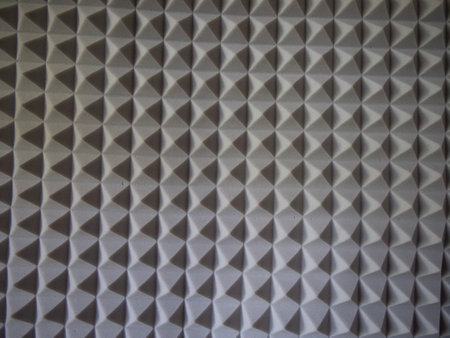 Gray acoustic foam rubber. Soundproof pyramids, full frame.