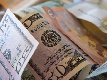 Paper bills of dollars and euros, close-up. Dollars and euros are mixed up.の写真素材