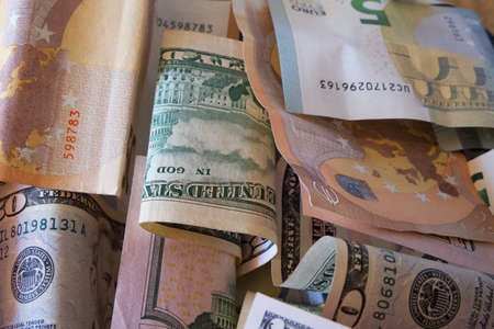 Paper bills of dollars and euros, close-up. Dollars and euros are mixed up.の写真素材