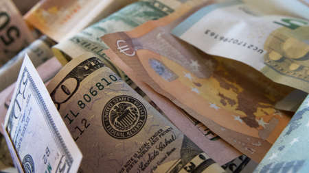 Paper bills of dollars and euros, close-up. Dollars and euros are mixed up.の写真素材