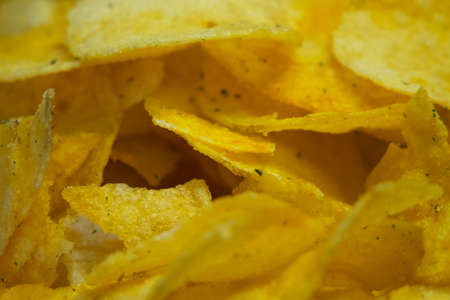 Spiced potato chips, a close-up shot. Fried potatoes.の写真素材