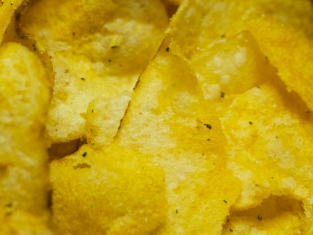Spiced potato chips, a close-up shot. Fried potatoes.