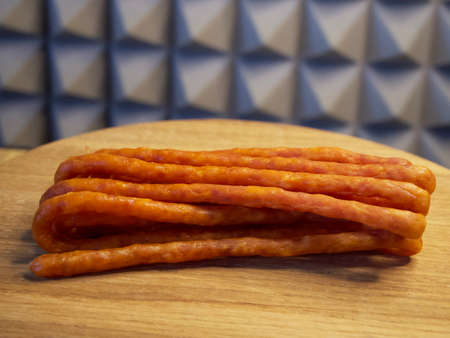 Polish smoked cabanossi sausages on a wooden surface.