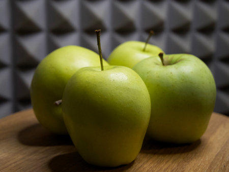 Four large apples, close-up. Fruit on a wooden surface.の写真素材