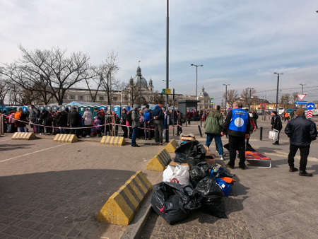 Lviv, Ukraine, April 4, 2022. Refugees on the forecourt are waiting for their buses to European...