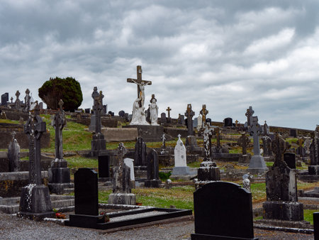 West Cork, Ireland, May 2, 2022. An Catholic cemetery on a cloudy spring day. stone tombstones. Cemetery of Darrara in Cork County of Ireland. headstoneのeditorial素材