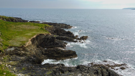 Beautiful Irish coast of the Atlantic Ocean, top view. Nature of Northern Europe. Coastal rocks covered with green grass.の写真素材