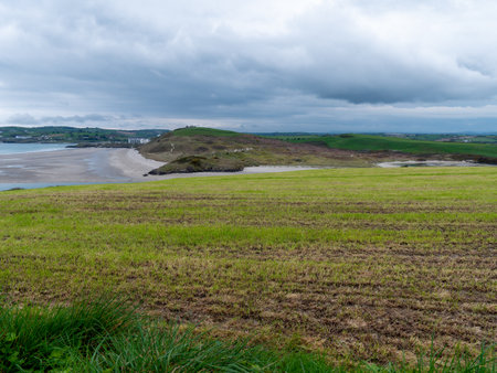 Picturesque hills in the south of Ireland, a view of the Clonakilty seashore. Cloudy, rainy weather. Landscapes along the Wild Atlantic Way. Nature of Northwestern Europe.の写真素材