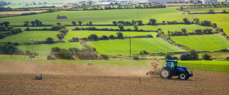 County Cork, Ireland, August 20, 2022. A tractor sows a plowed field on a summer day in Ireland....