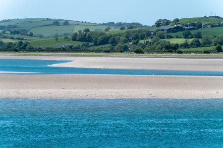 A sandbank at low tide, spring day. The sea water is a beautiful turquoise color. Sea coast landscape.の写真素材
