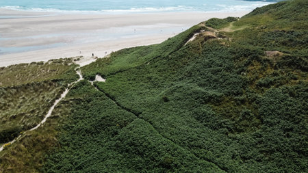 A hillside covered with plants on the shore of the Atlantic Ocean, top view. Beautiful Irish seaside...