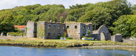 Ruins of an ancient stone building on the shore in Ireland on a sunny day. The ruins of Arundel Grain Store, Ring, near Clonakilty, West Cork.の写真素材