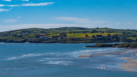 View of the famous Irish beach of Inchydoney on a sunny summer day. The beautiful Atlantic coast of Ireland. Summer seaside resort, landscape, body of water aerial view. clear blue sky over sea coastの写真素材