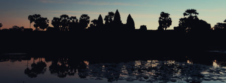 Mystical dawn at Angkor Wat, Cambodia, with a dark sky and haunting silhouettes of trees painting a captivating landscape.の写真素材