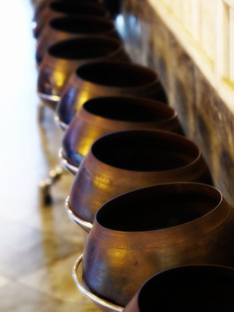 A captivating sight within the Temple of the Reclining Buddha in Bangkok: a row of large pots...
