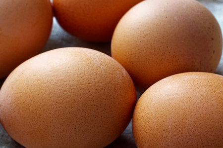 Freshly laid brown eggs with distinct textures, emphasizing farm-to-table and natural food movements.の写真素材