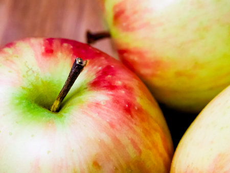 Colorful Apple Composition. Apples with varying shades, set against wood, suitable for dietary content.の写真素材