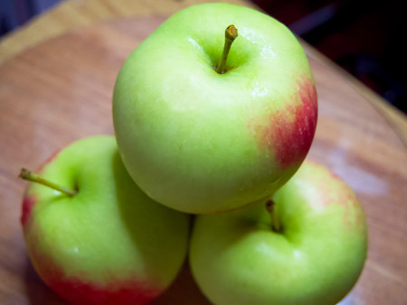 Ripe Apple Assortment. A selection of fresh apples, prominently featuring stems.の写真素材