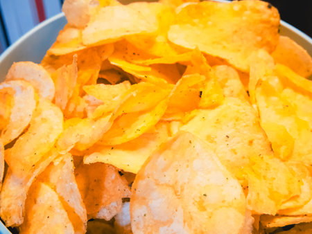 Party Chips. Crunchy chips set against a playful background, suitable for party food visuals.の写真素材