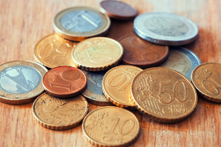 Euro Coin Assortment. Various Euro coins on wood, showcasing currency. Uses forFinancial blogs, currency exchange sites.の写真素材