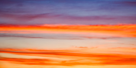 The sky ablaze with warm colors transitioning into cool tones, capturing nature's artistry. Perfect for inspirational themes.の写真素材