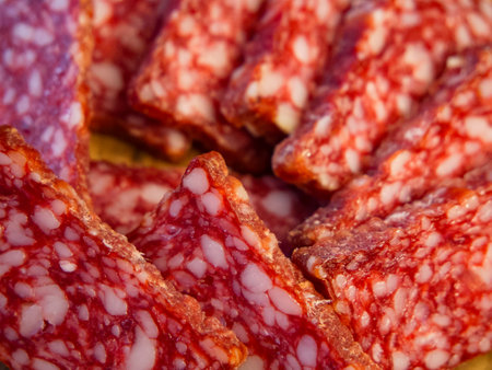 Salami Slices Close-Up. Stacked salami slices with visible marbling, ideal for food-related content.の写真素材
