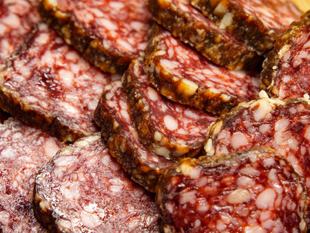 Cured Meat Detail. Detailed salami texture showing marbled fat, suitable for cookbooks and food marketing.の写真素材