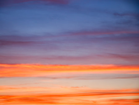 A picturesque view of the evening sky's vibrant yet calming colors; perfect for desktop wallpapers or screensavers.の写真素材