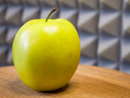 Apple on wooden texture, reflects organic quality, useful for eco-friendly product branding.の写真素材