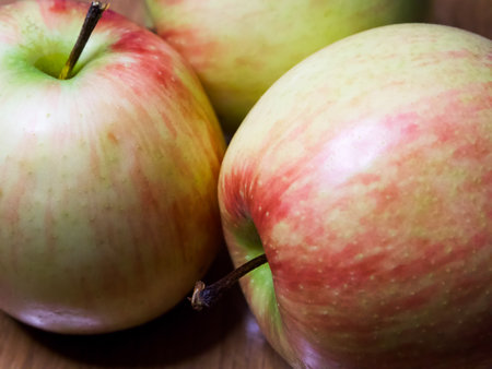 Organic Apples on Wood. A group of apples on a wooden backdrop, perfect for organic food marketing.の写真素材