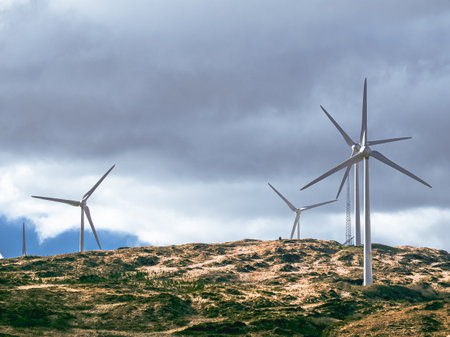 The wind turbines are a testament to the power of technology, a force that can solve our energy needs.の写真素材