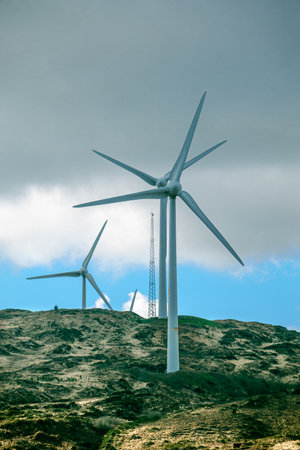 The wind turbines are part of a wind farm, a cluster of turbines harnessing the power of the wind.の写真素材