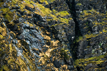 The Carrauntoohil walkway in Ireland, taking in breathtaking views of rocky cliffs and vibrant greenery. The trail offers a challenging adventure for nature enthusiasts.の写真素材