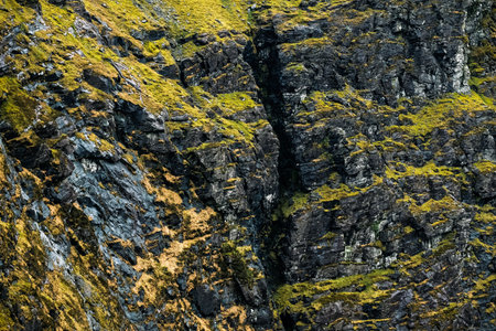 Explore the stunning Carrauntoohil walkway in Ireland surrounded by rocky landscapes and lush greenery.の写真素材