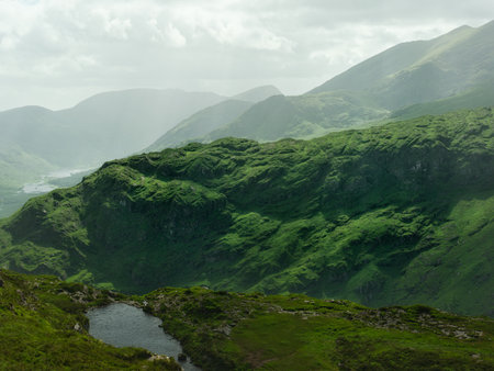 View from high ground overlooks scenic Gap of Dunloe valley and mountain range in County Kerry, Ireland.の写真素材
