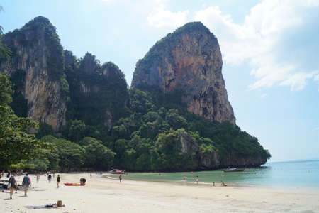 People enjoying the blue sky and turquoise beach in Krabi, Thailandの写真素材