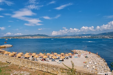 people relax on the shores of the sea on a Sunny day in summer under blue skyの写真素材