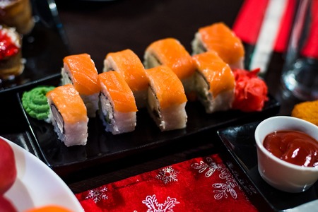 rolls with fish and avocado on plate with sauce, ginger, wasabiの写真素材
