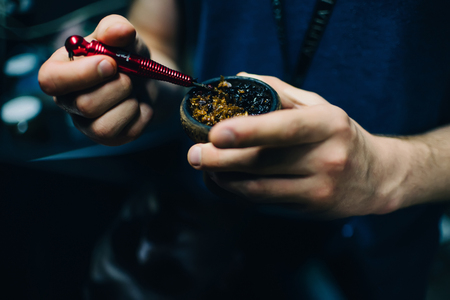men hands mixing different tobacco for Shisha in the bowlの写真素材