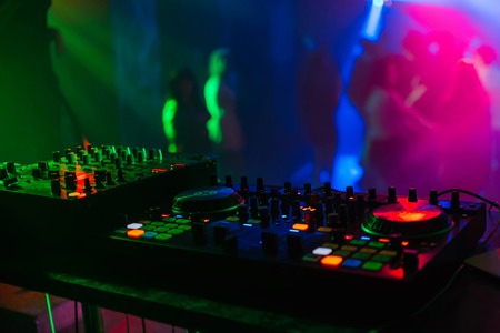 mixer Board for professional DJ disks under colored lightsの写真素材