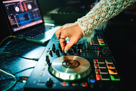 hand girl DJ with make-up and ring mixing music on professional Boardの写真素材